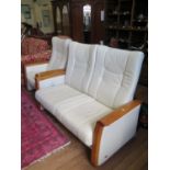 A Himolla cream leather two seat settee and matching armchair, settee 148 cm wide