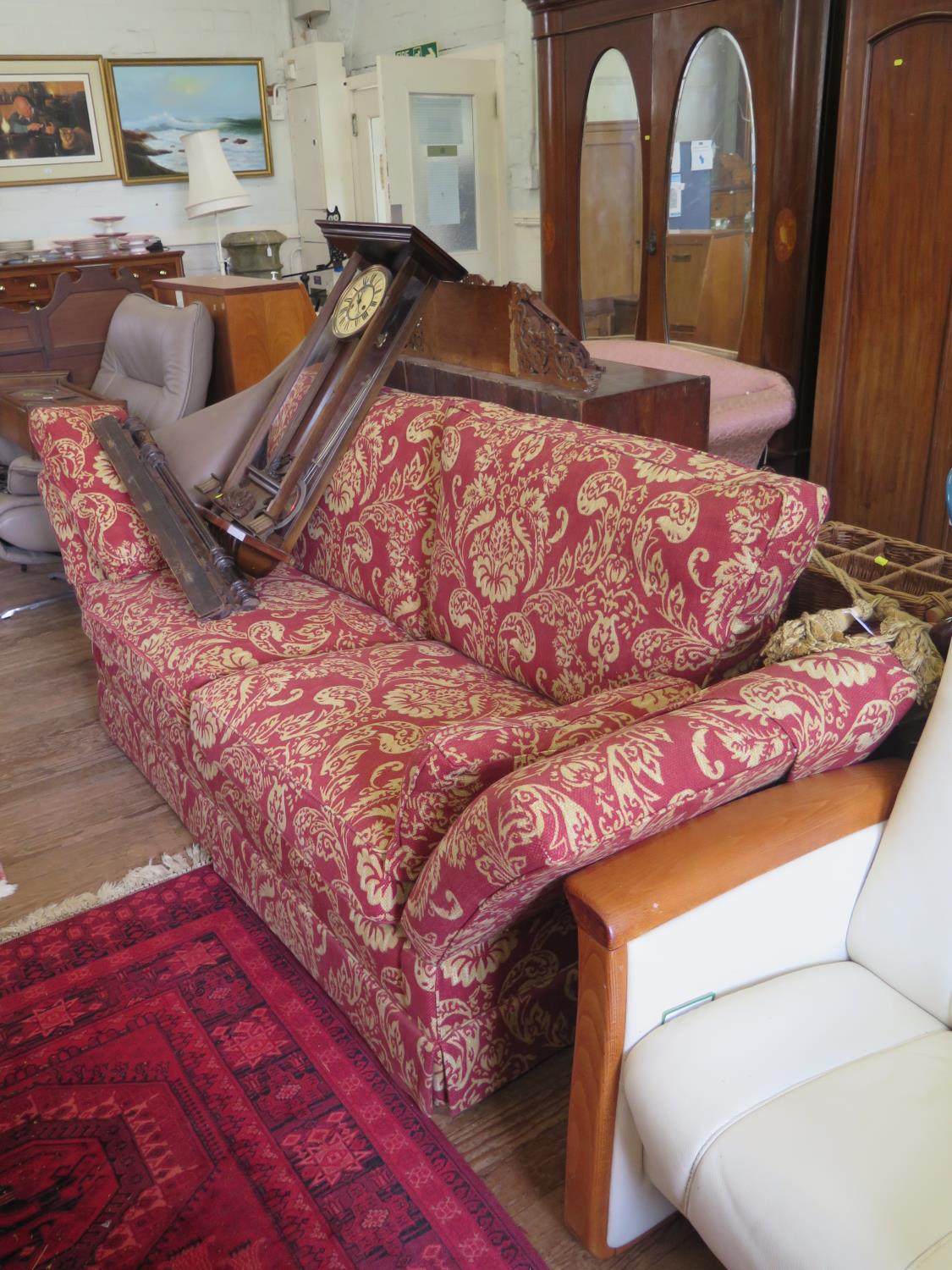 A Knole style settee, with red foliate design upholstery, 223 cm wide