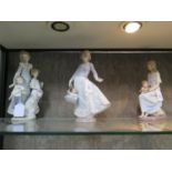 A Lladro figure group 'Sunday Best', number 5758, 31 cm high, and two other Lladro figures of