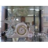 A Lladro table lamp, with a child sitting on an outstretched dove, 33 cm high, a Lladro table clock,