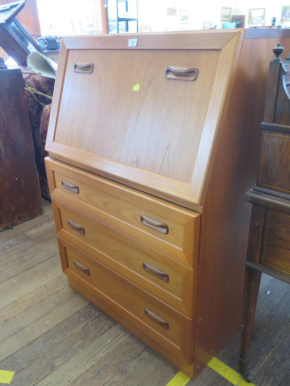 A G-Plan teak bureau, the fall front enclosing loose pigeonholes, over three drawers, 75 cm wide,