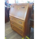 A G-Plan teak bureau, the fall front enclosing loose pigeonholes, over three drawers, 75 cm wide,