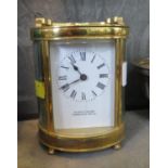 An oval brass carriage timepiece clock, inscribed Alfred Taylor Tunbridge Wells, with enamelled