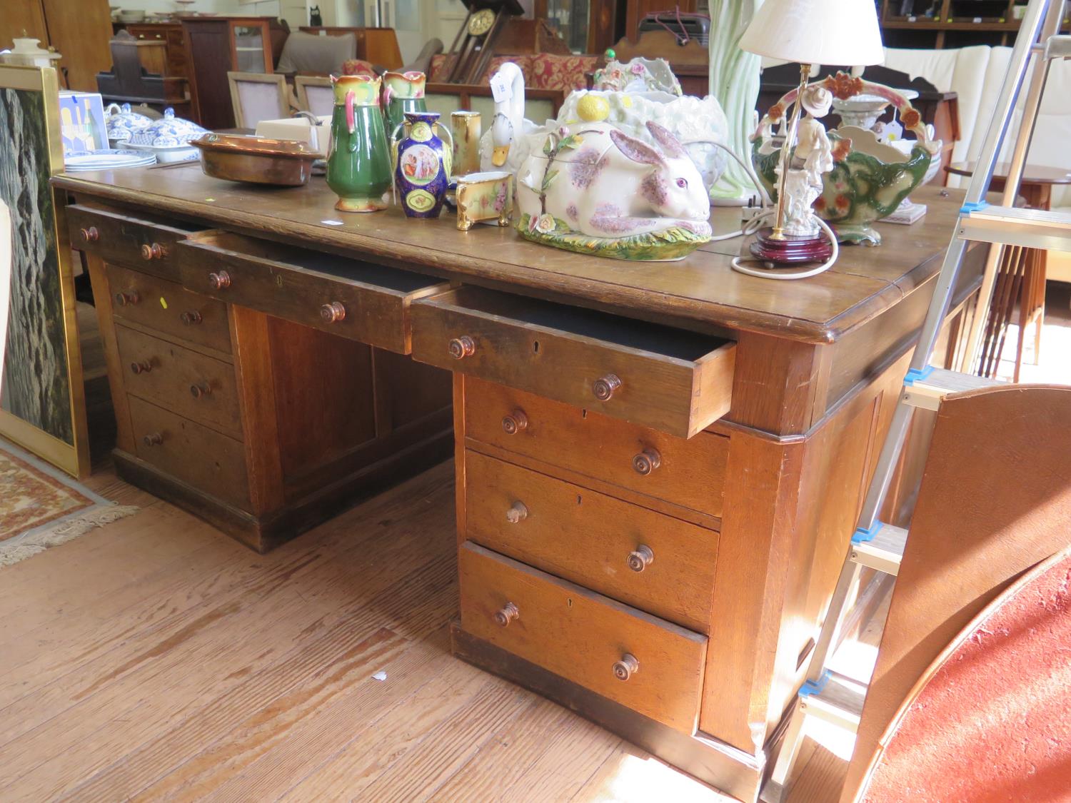 An early 20th century oak partner's desk, one side with three frieze drawers over three drawers in