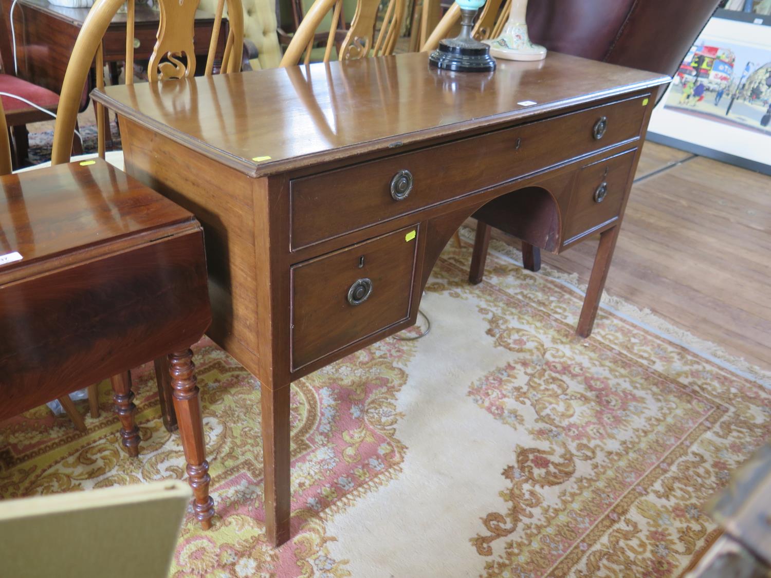 A mahogany dressing table, the long frieze drawer over a kneehole and two deep drawers on square