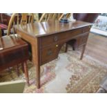 A mahogany dressing table, the long frieze drawer over a kneehole and two deep drawers on square
