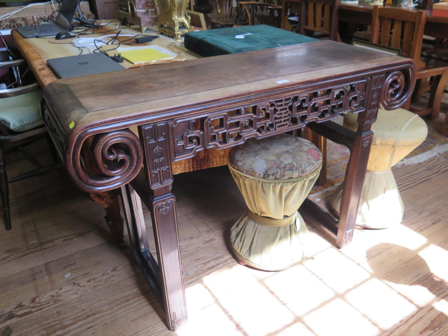 A Chinese hardwood altar or side table, possibly Huang Huali, the top with curved ends above a