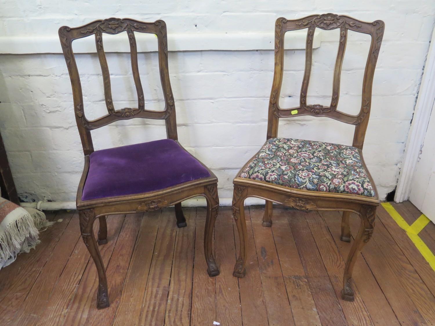 A pair of French walnut dining chairs, the foliate carved rail backs over drop in seats on carved