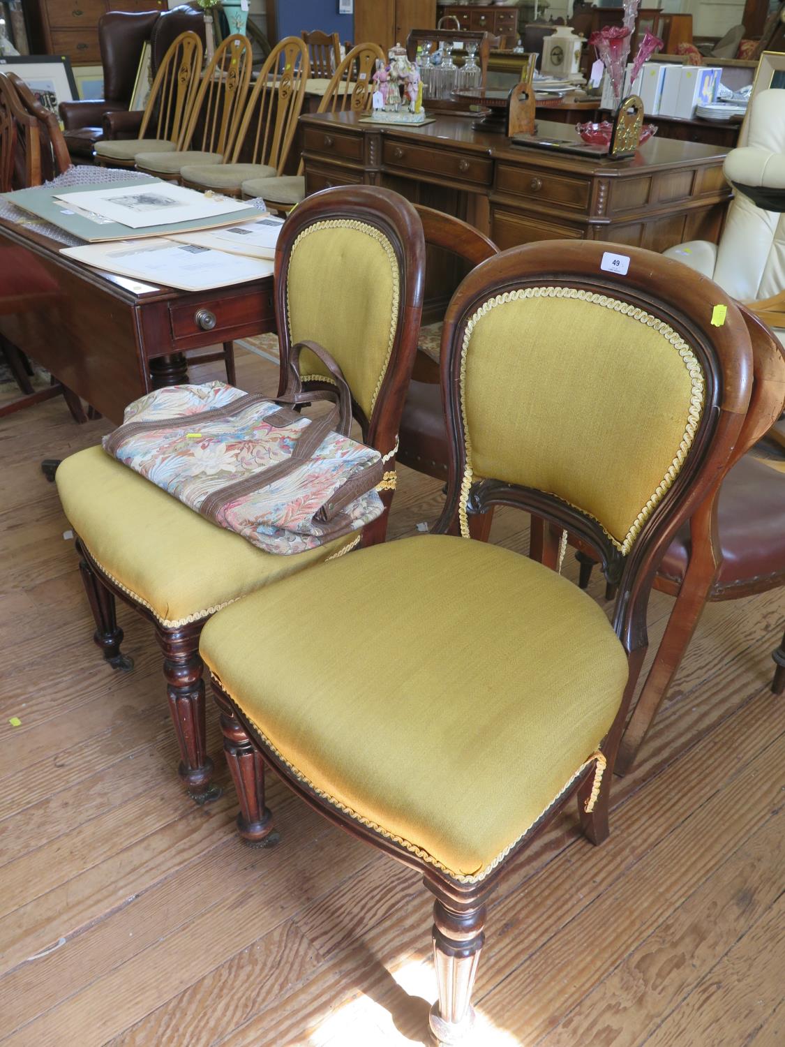 A pair of Victorian mahogany dining chairs, the upholstered backs and seats on reeded tapering