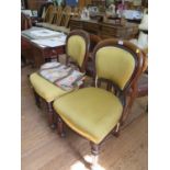 A pair of Victorian mahogany dining chairs, the upholstered backs and seats on reeded tapering
