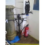 A black painted wrought iron weather vane, painted with an owl, 124 cm high