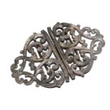 A silver belt buckle, of foliate scroll form, 8.5 cm wide