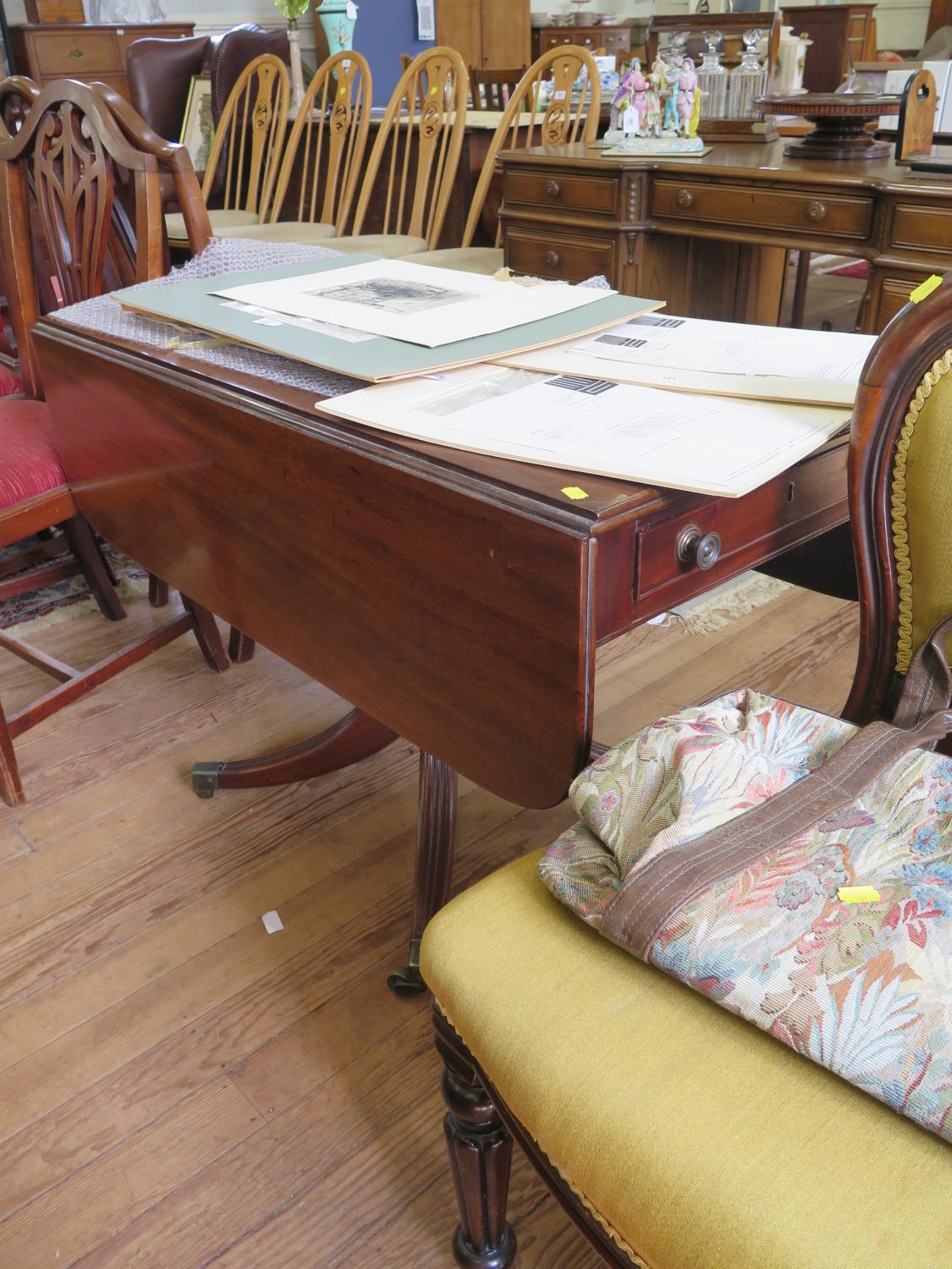 A Regency mahogany Pembroke table, the rectangular top with drop leaves over a single frieze