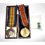 A Royal Ulster Constabulary service medal tie pin badge and two World War I medals