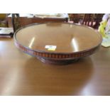 A mahogany lazy susan, with chequer banded edges, circular on a moulded circular base, 40.5 cm