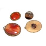 A collection of two agate brooches and two agate pendants, one set with stones