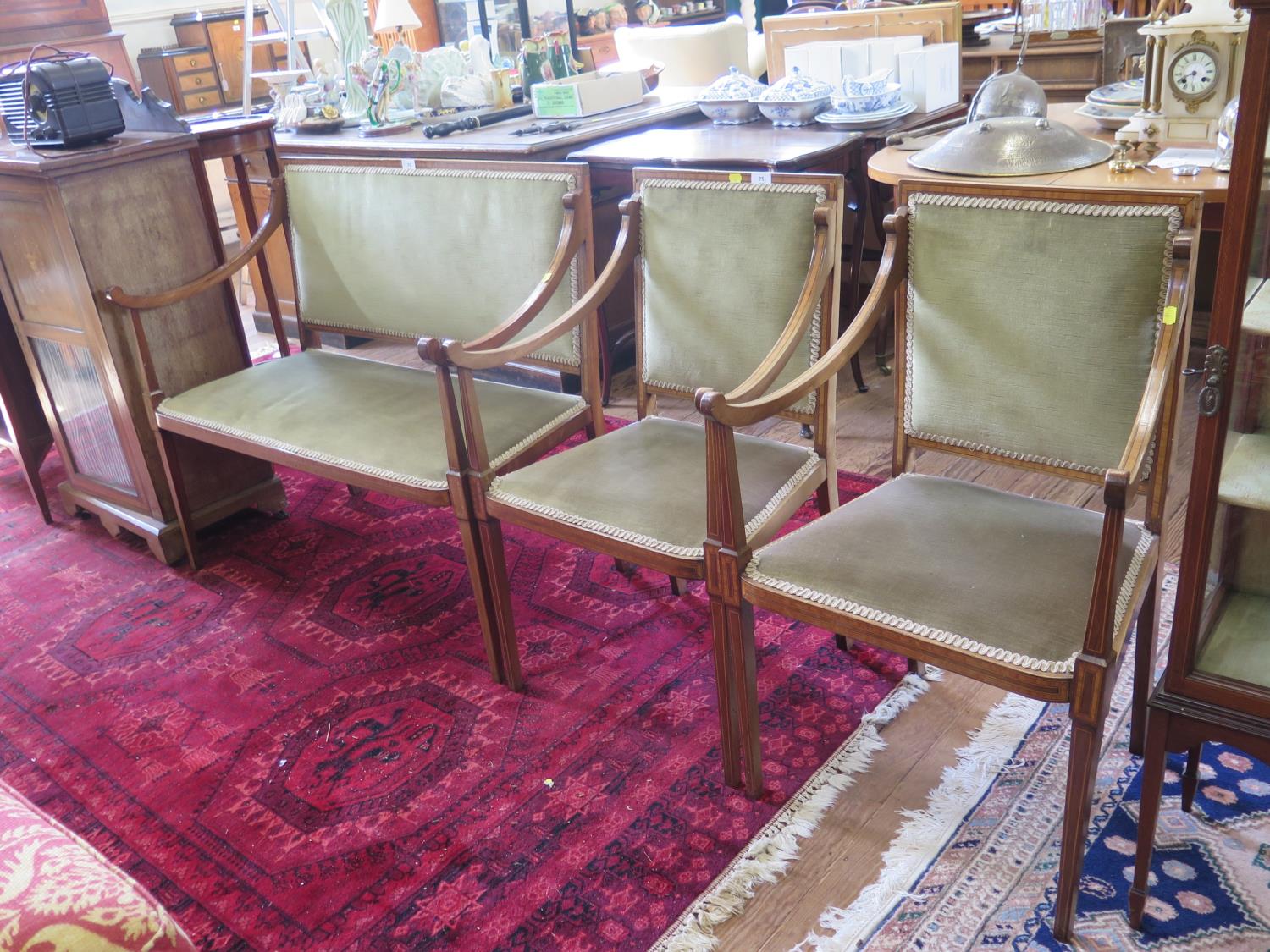 An Edwardian mahogany and satinwood crossbanded two seat settee and two matching chairs, with