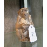 A Royal Copenhagen figure of a seated monkey, numbered 1454/1444, 13 cm high