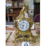 A French gilt metal mantel clock case, the putti playing a harp over foliate scrolls and flaming