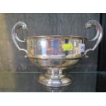 A silver twin handled trophy cup, 27 cm wide, 17.5 cm high