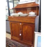 A mid Victorian mahogany chiffonier, the raised back with shelf over a long drawer and a pair of