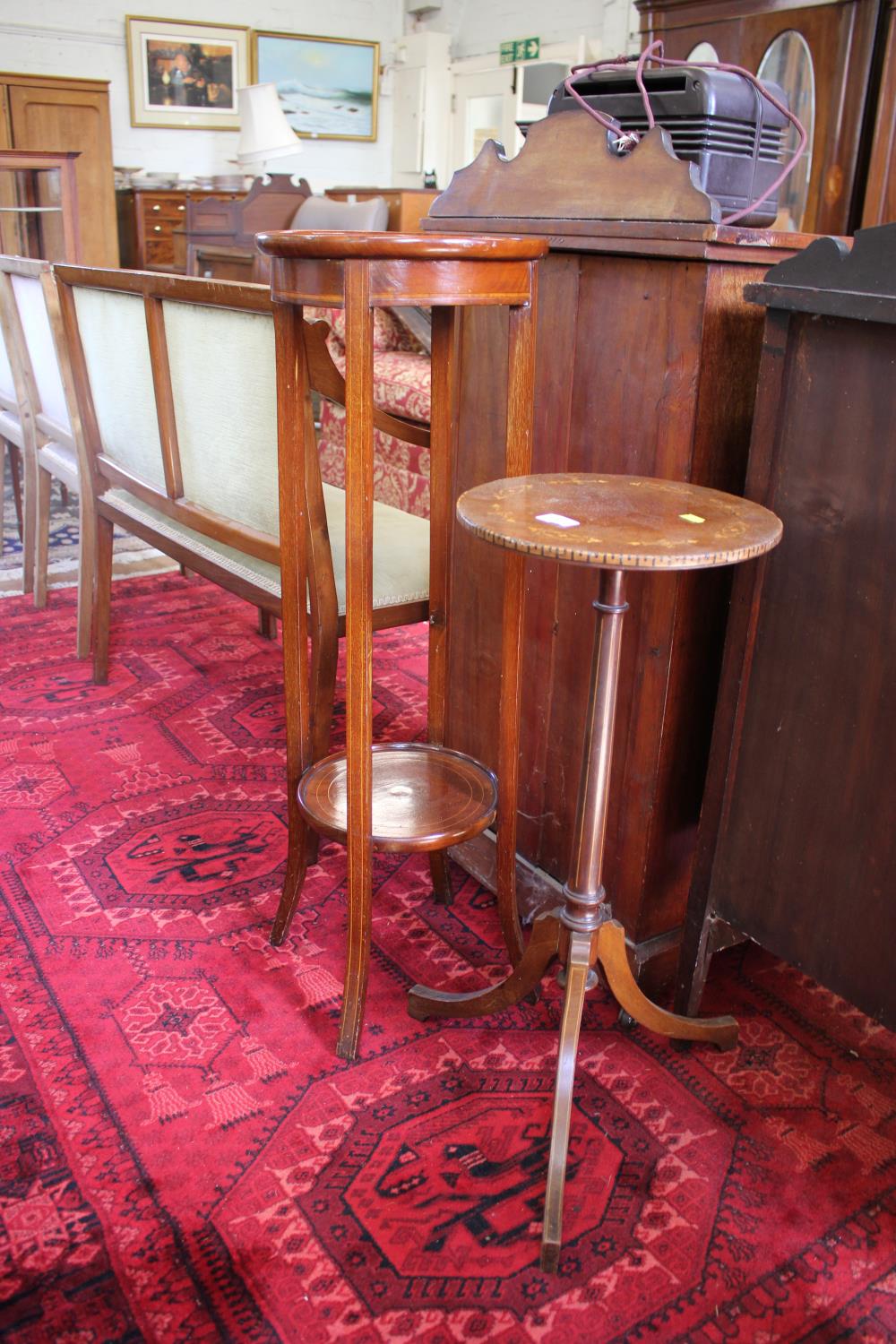 An inlaid mahogany tripod torchere stand, the foliate inlay top on boxwood strung tapering stem