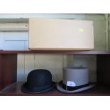 A Dunn & Co. bowler hat, and a Moss Bros grey top hat (2)