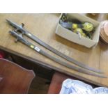 Two Indian Tulwar swords, one with engraved decoration, 88cm long, the other as found 82cm long,