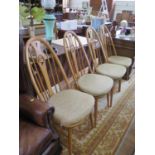 A set of four Ercol ash Windsor type dining chairs, the splats with pierced carving of swans (4)