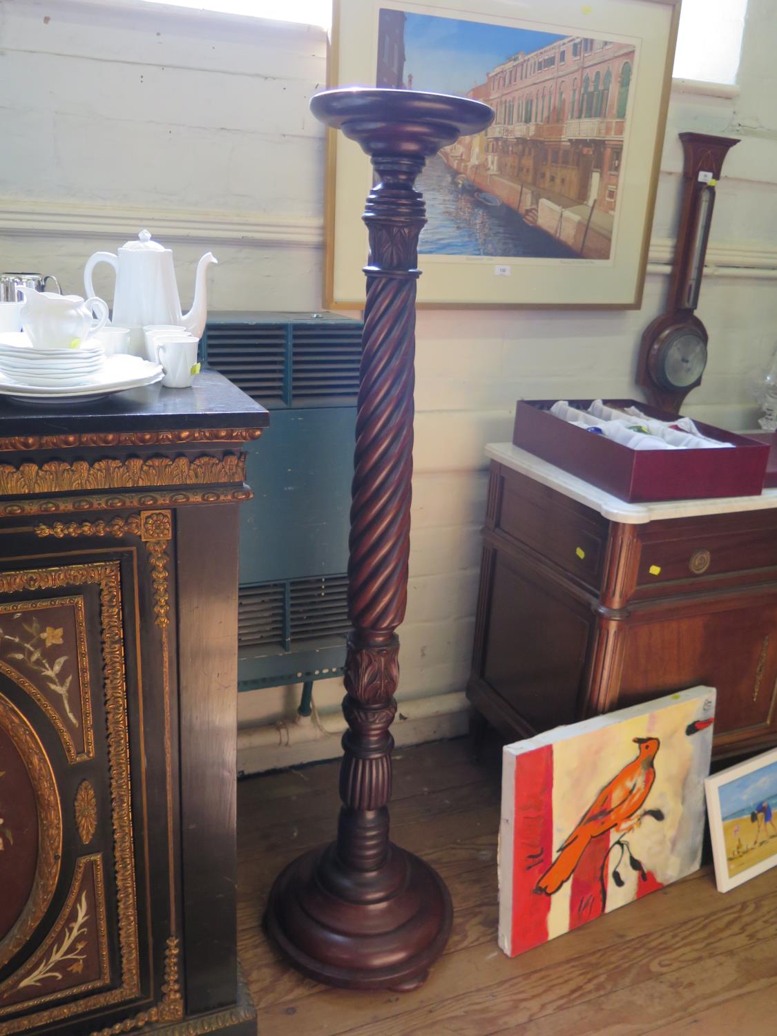 A mahogany torchere stand, with barleytwist and acanthus carved stem on a moulded circular base, 142