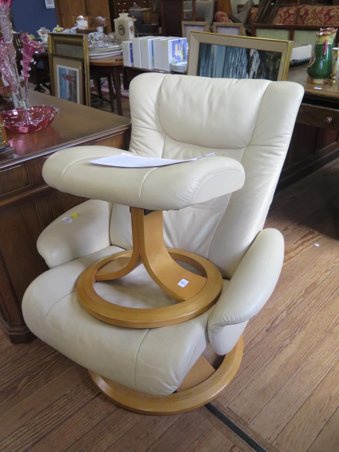 A Stressless cream leather adjustable armchair and foot stool (2)