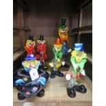 A collection of Murano glass multi coloured clown models comprising four small figures one large and