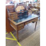 An Edwardian inlaid rosewood writing desk, the raised mirrored back with trinket drawers, over a