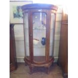 A French style stained beech demi-lune display cabinet, with single glazed door over foliate