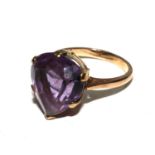 A 9 carat gold ring set with amethyst colour stone