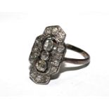 A three stone diamond cluster ring, vertical set with old cut diamonds around the central three