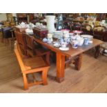 A hardwood dining table and seven dining chairs, in the rustic style, the table top inset with