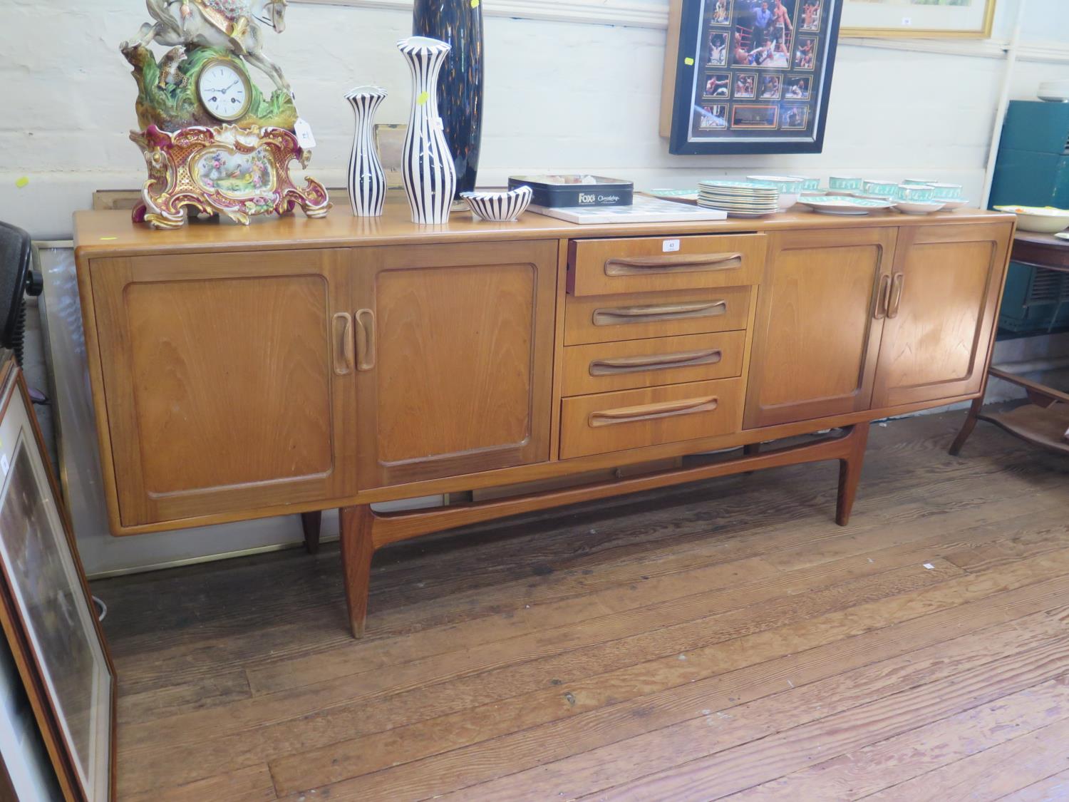 A G-Plan teak sideboard, the four central drawers flanked by a pair of cupboard doors on tapering