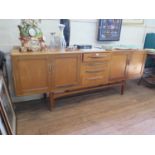 A G-Plan teak sideboard, the four central drawers flanked by a pair of cupboard doors on tapering