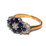 A diamond and sapphire cluster ring set in yellow gold