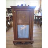 An Edwardian mahogany and satinwood crossbanded music cabinet, the raised back over a glazed and