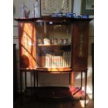 An Edwardian mahogany and satinwood crossbanded display cabinet, the protruding cornice over a bowed