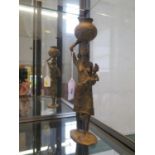 An African bronze figure of a mother carrying her child and a vessel, 31 cm high