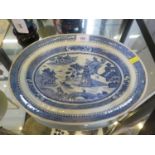 A Chinese blue and white oval plate, depicting pagodas and figures by water, 34 cm wide