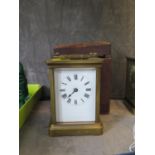 A brass carriage timepiece clock, of conventional form, with enamel dial, and fitted case, one