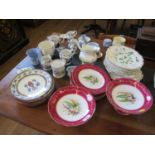 A set of six hand painted plates with maroon borders and floral sprays, 23 cm diameter, a pair of