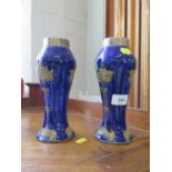 A pair of Royal Doulton stoneware baluster form vases, with silver rims, stylised floral design on a