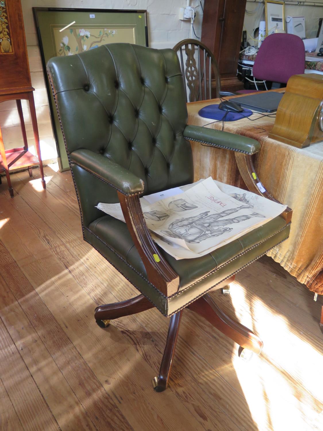 A green leather button back office armchair