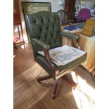 A green leather button back office armchair