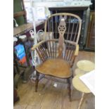 A 19th century ash and elm high wheelback Windsor chair, with shaped splat over a moulded seat on